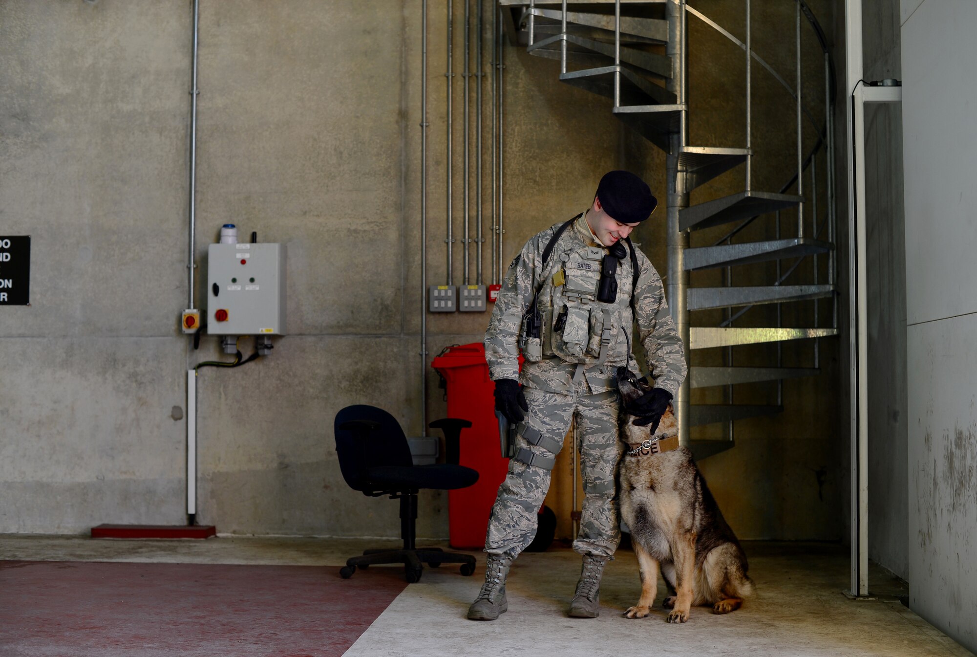 Senior Airman Bryce Bates, 48th Security Forces Squadron military working dog handler, interacts with his teammate, Gina, before a vehicle inspection at Royal Air Force Lakenheath, England, April 11, 2016. Bates has been providing additional care for Gina after a cancerous tumor was recently removed from her mouth. (U.S. Air Force photo/Senior Airman Erin Trower)