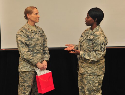 U.S. Air Force Maj. Kellie Courtland, the 509th Logistics Readiness Squadron (LRS) commander, left, receives a takeaway from Senior Master Sgt. Felicia Williams, the 509th LRS asset management superintendent, during the closing comments of the Women’s History Month Breakfast at Whiteman Air Force Base, Mo., March 30, 2016. Courtland was the guest speaker during the breakfast and spoke about the work that women still have ahead of them in the Air Force. (US Air Force photo by Senior Airman Jovan Banks)