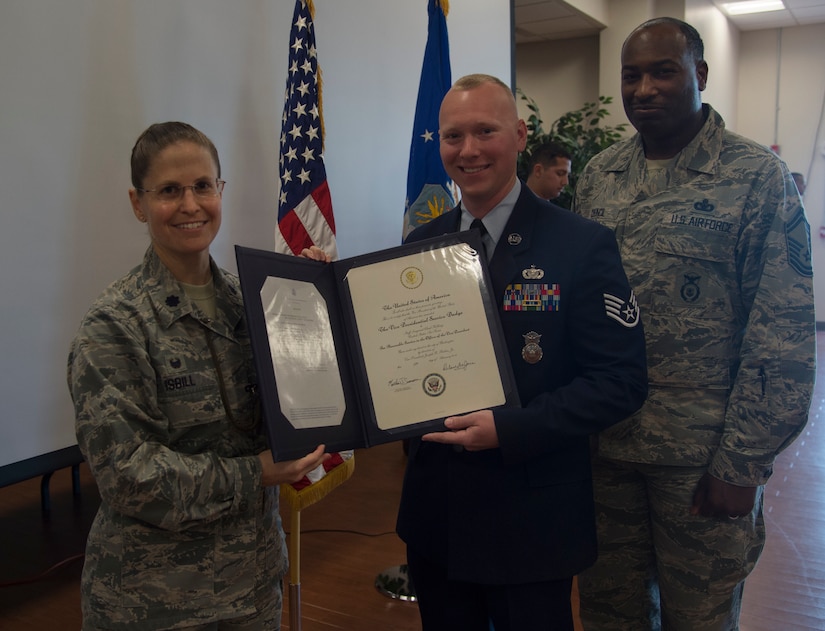 Lt. Col. Sarah Isbill, the 811th Security Forces Squadron commander, poses for a picture with Staff Sgt. Chad Holling, 811th SFS vice presidential security team leader, and Senior Master Sgt. Dana Council, 811th SFS manager, during the Vice Presidential Service Badge awards ceremony at Joint Base Andrews, Md., April 15, 2016. The VPSB is awarded to military members who serve as a full-time uniformed service aide to the VP of the United States of America. (U.S. Air Force photo by Senior Airman Mariah Haddenham/Released)