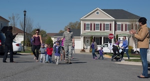 Members of Joint Base Andrews Family Child Care march in a purple parade to celebrate National Purple Up day at Liberty Park Housing Office, April 15, 2016. Purple Up day is part Month of the Military Child, a time to honor military youth for the important role they play contributing to the strength of the military family. (U.S. Air Force photo by Airman 1st Class Rustie Kramer/Released)