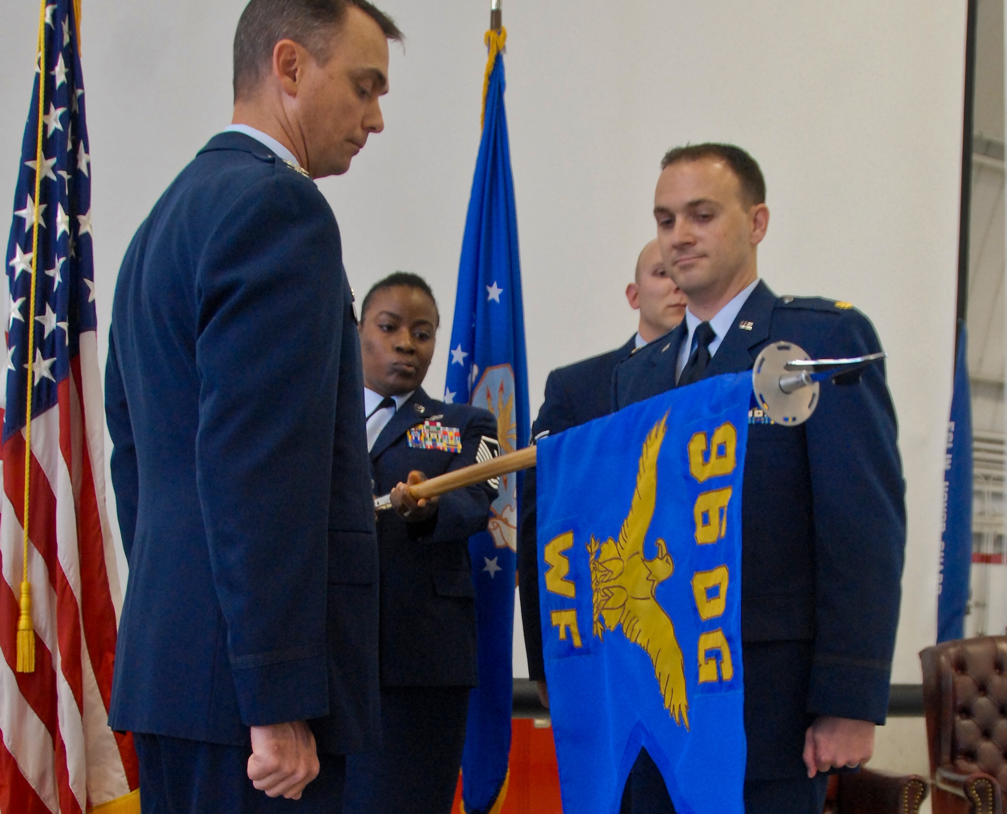 Maj. Paul Homan (right), 96th Weather Squadron commander and Col. Scott Thompson, 96th Operations Group commander watch as the 96th Weather Flight guidon is furled at the squadron activation ceremony April 14 at Eglin Air Force Base, Fla.  The new squadron was previously named the 96th Weather Flight since 2011.  (U.S. Air Force photo/Kevin Gaddie)  