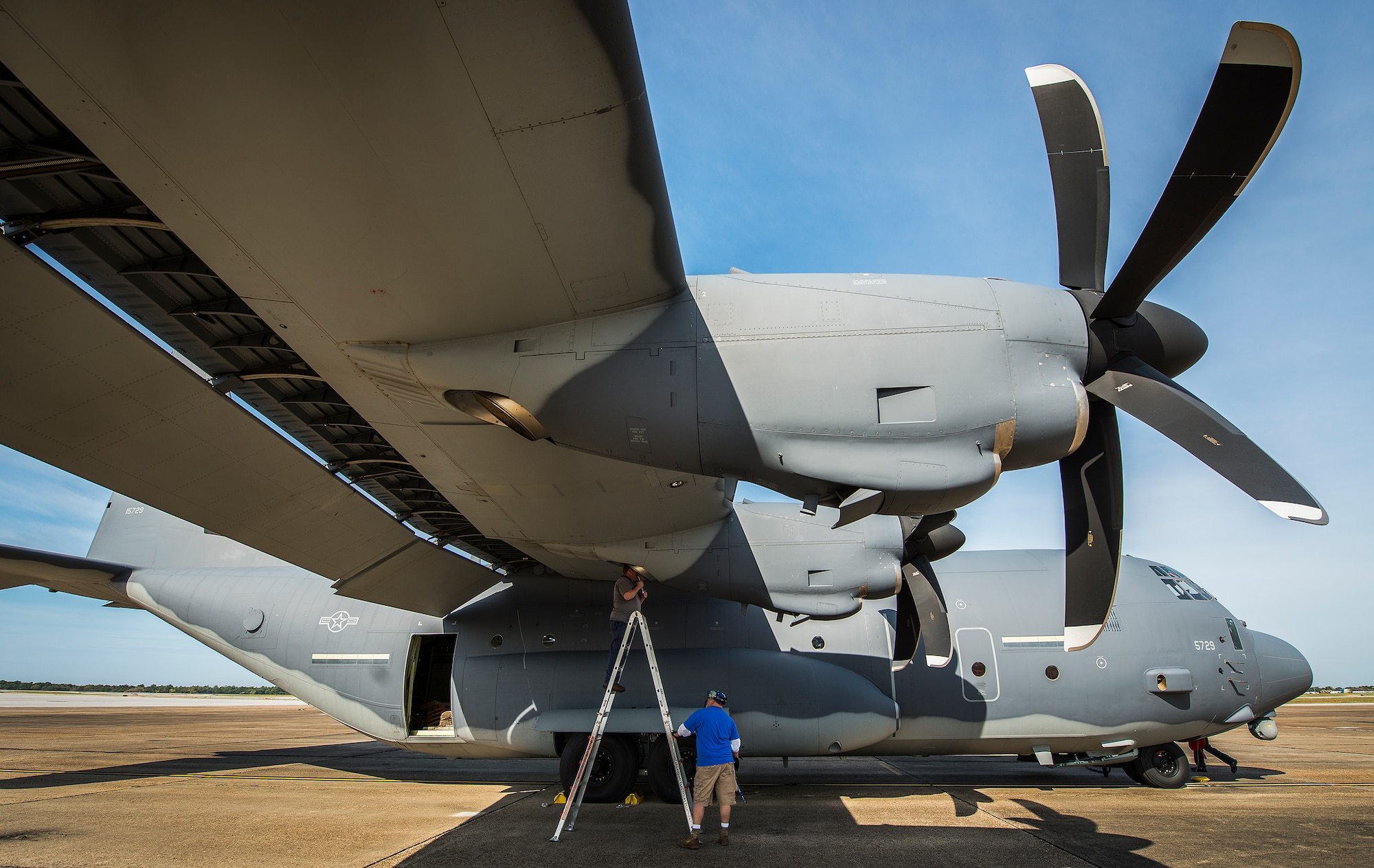 Maintenance contractors with the 414th Flight Test Squadron perform engine checks on a test MC-130J at Eglin Air Force Base, Fla.  The aircraft was fitted with vertical fins on each wing, called winglets.  The 413th Flight Test Squadron aircrew and engineers tested the modified aircraft over eight flights.  The goal of the tests was to collect data on possible fuel efficiency improvements and performance with the winglets and lift distribution control system installed.  (U.S. Air Force photo/Samuel King Jr.)
