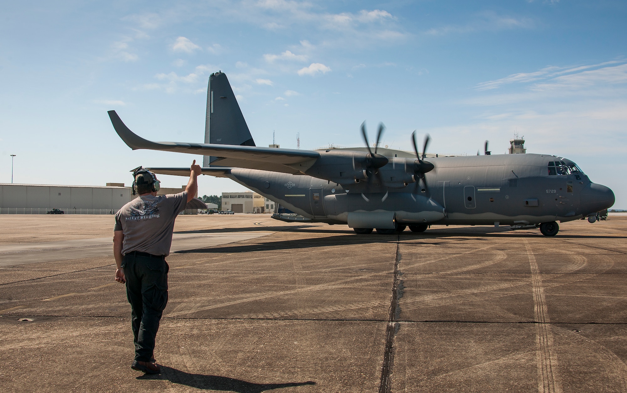 Jeff Frisbe, a Lockheed Martin maintenance contractor, sends out a modified MC-130J for a test mission with a thumbs up at Eglin Air Force Base, Fla. The test aircraft was fitted with vertical fins on each wing, called winglets.  The 413th Flight Test Squadron aircrew and engineers tested the modified aircraft over eight flights.  The goal of the tests was to collect data on possible fuel efficiency improvements and performance with the winglets and lift distribution control system installed.  (U.S. Air Force photo/Samuel King Jr.)