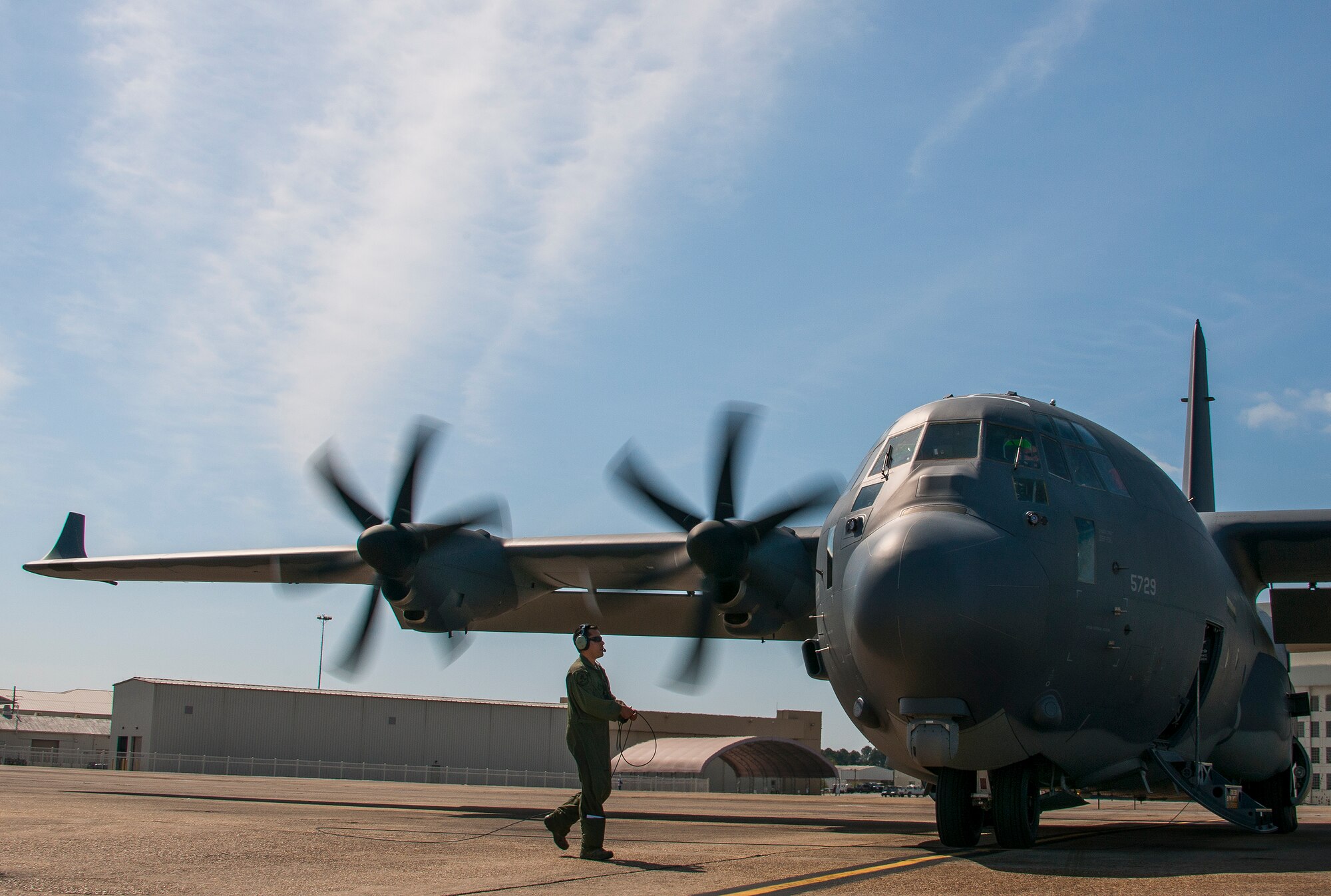 Tech. Sgt. Robert Waller, a 413th Flight Test Squadron loadmaster, moves to the other side of the modified MC-130J to begin engine spin up prior to a mission at Eglin Air Force Base, Fla. The test aircraft was fitted with vertical fins on each wing, called winglets.  The 413th Flight Test Squadron aircrew and engineers tested the modified aircraft over eight flights.  The goal of the tests was to collect data on possible fuel efficiency improvements and performance with the winglets and lift distribution control system installed.  (U.S. Air Force photo/Samuel King Jr.)