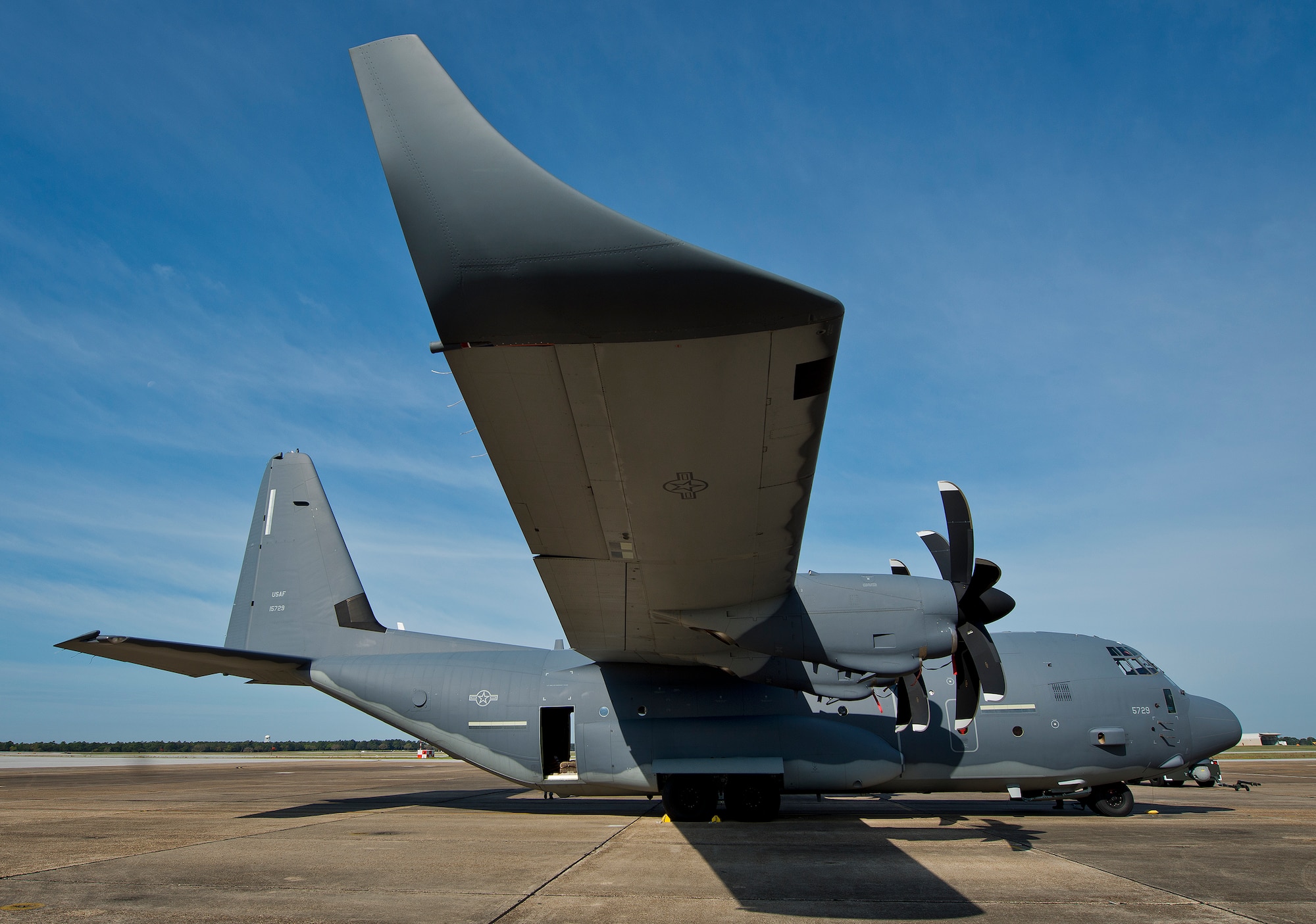A modified MC-130J awaits its next mission at Eglin Air Force Base, Fla.  The aircraft was fitted with vertical fins on each wing, called winglets.  The 413th Flight Test Squadron aircrew and engineers tested the modified aircraft over eight flights.  The goal of the tests was to collect data on possible fuel efficiency improvements and performance with the winglets and lift distribution control system installed.  (U.S. Air Force photo/Samuel King Jr.)