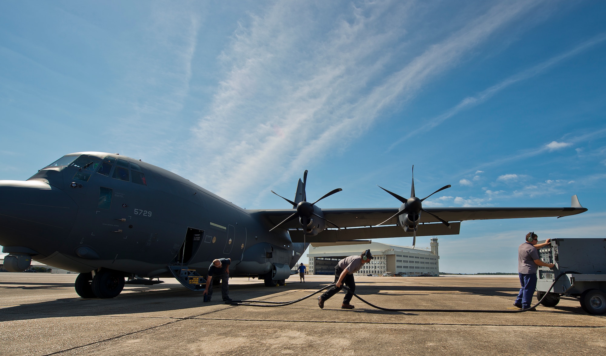 Lockheed Martin maintenance contractors pull the generator cable way from an MC-130J prior to a mission at Eglin Air Force Base, Fla. The test aircraft has been fitted with vertical fins on each wing, called winglets.  The 413th Flight Test Squadron aircrew and engineers tested the modified aircraft over eight flights.  The goal of the tests was to collect data on possible fuel efficiency improvements and performance with the winglets and lift distribution control system installed.  (U.S. Air Force photo/Samuel King Jr.)