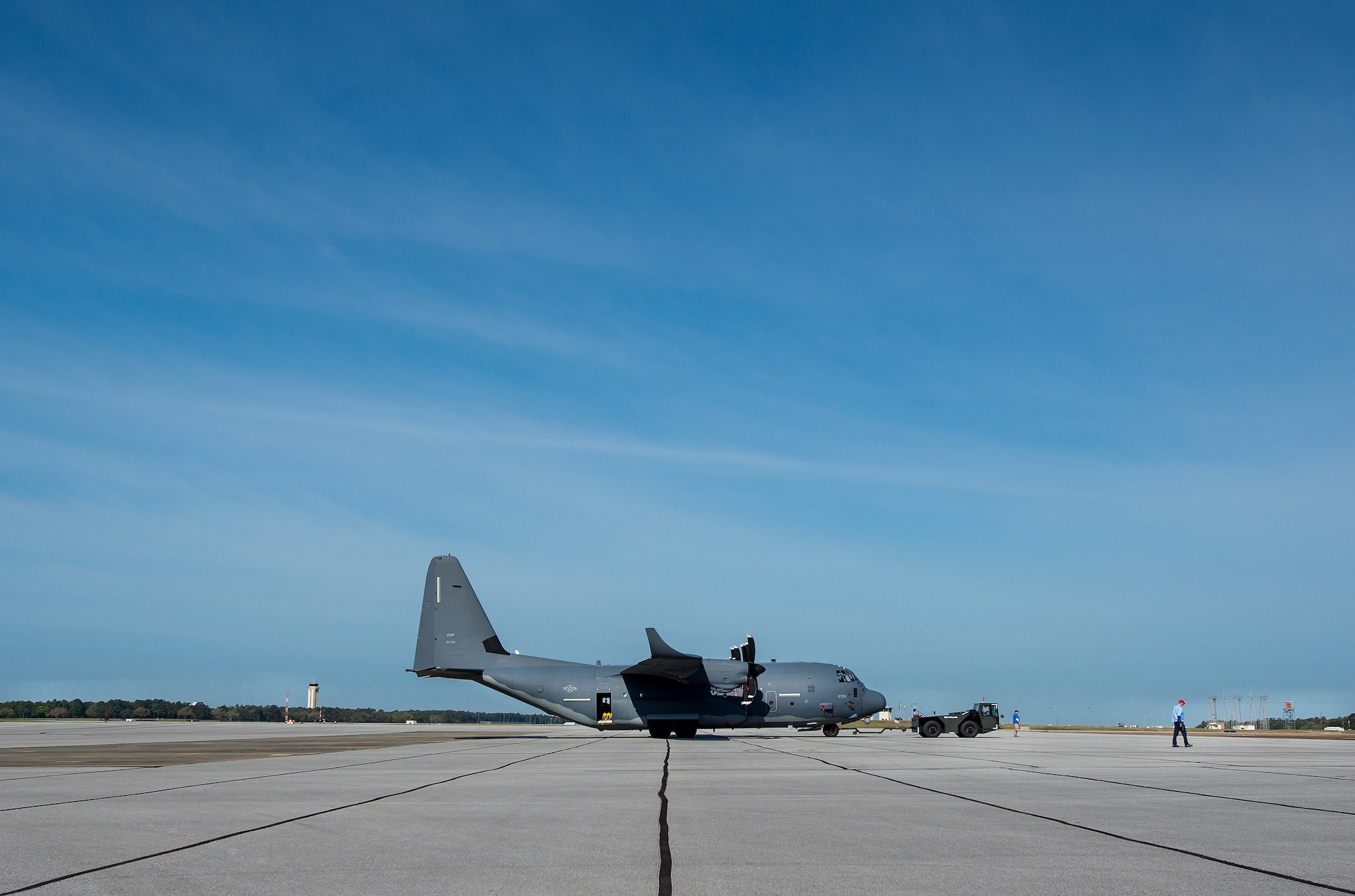 A modified MC-130J is pulled to its parking spot by an aircraft tow vehicle at Eglin Air Force Base, Fla. The test aircraft has been fitted with vertical fins on each wing, called winglets.  The 413th Flight Test Squadron aircrew and engineers tested the modified aircraft over eight flights.  The goal of the tests was to collect data on possible fuel efficiency improvements and performance with the winglets and lift distribution control system installed.  (U.S. Air Force photo/Samuel King Jr.)
