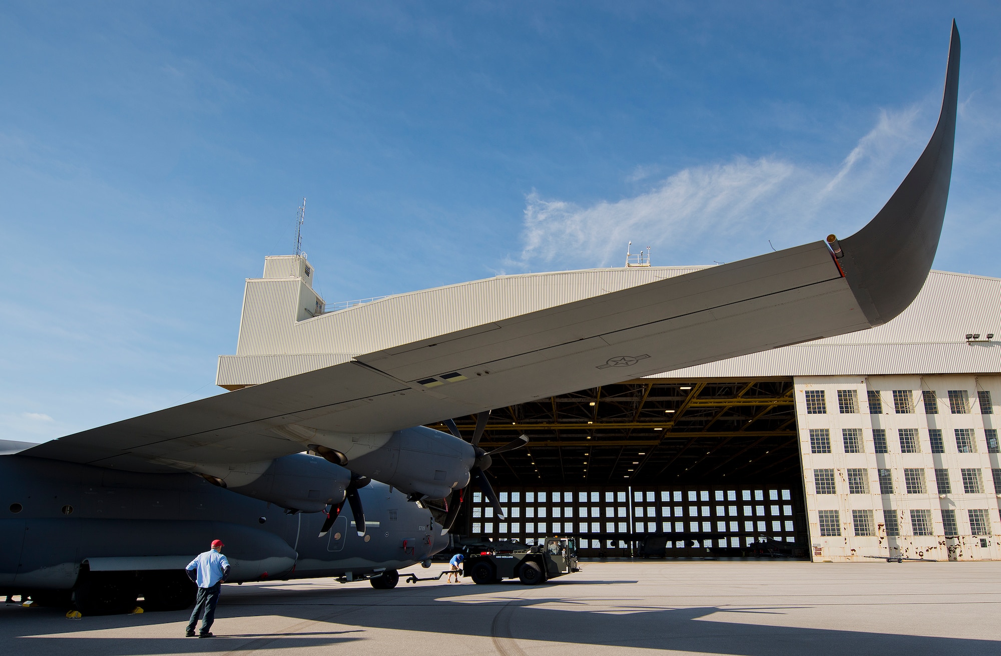 A Lockheed Martin contractor attaches the MC-130J to an aircraft tow vehicle at Eglin Air Force Base, Fla. The test aircraft has been fitted with vertical fins on each wing, called winglets.  The 413th Flight Test Squadron aircrew and engineers tested the modified aircraft over eight flights.  The goal of the tests was to collect data on possible fuel efficiency improvements and performance with the winglets and lift distribution control system installed.  (U.S. Air Force photo/Samuel King Jr.)