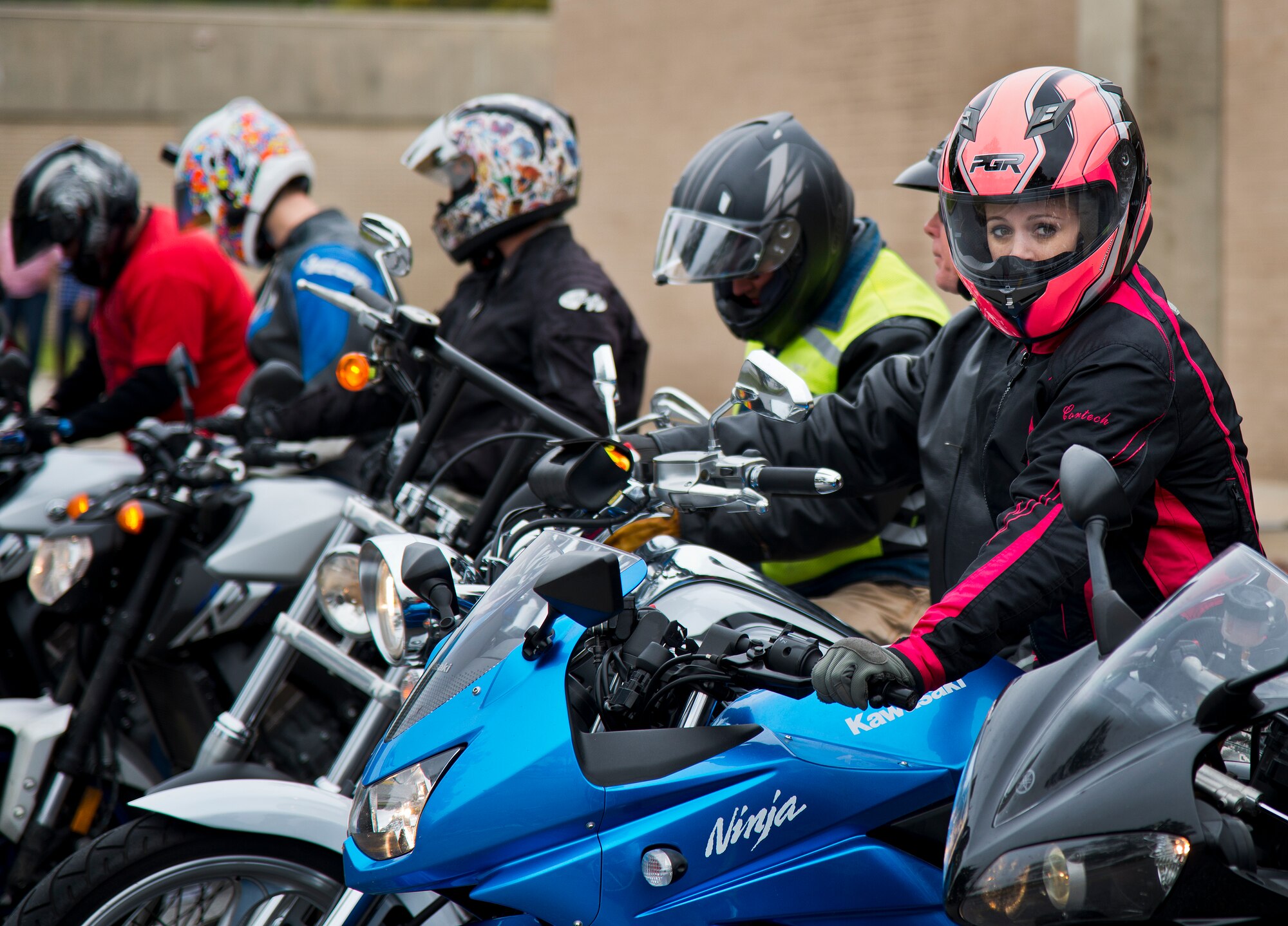 A female biker waits to begin a group ride with her squadron after the base’s annual motorcycle safety rally April 15 at Eglin Air Force Base, Fla.  Approximately 600 civilian and military riders rode in for the joint 53rd Wing/96th Test Wing event. (U.S. Air Force photo/Samuel King Jr.)