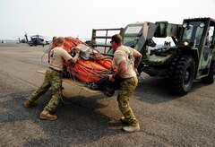 U.S. Army Sgt. Derrick Auten, 1st Battalion, 228th Aviation Regiment flight platoon sergeant, and Sgt. 1st Class Christopher Gagnon, 1-228 AVN REGT Flight Engineer, prepare to load a “Bambi Bucket” into a CH-47 Chinook helicopter in preparation for Joint Task Force-Bravo personnel to assist with firefighting efforts in Panama April 15, 2016 at Soto Cano Air Base, Honduras. (U.S. Army Photo by Martin Chahin/Released)