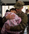 An Airman assigned to the 606th Air Control Squadron embraces his child before he leaves on a deployment in the 606th ACS compound at Spangdahlem Air Base, Germany, April 6, 2016. The 606th ACS is a self-contained mobile combat unit with Airmen covering more than 21 specialties. The unit provides  command and control support for U.S. Air Forces in Europe. (U.S. Air Force photo by Airman 1st Class Timothy Kim/Released)