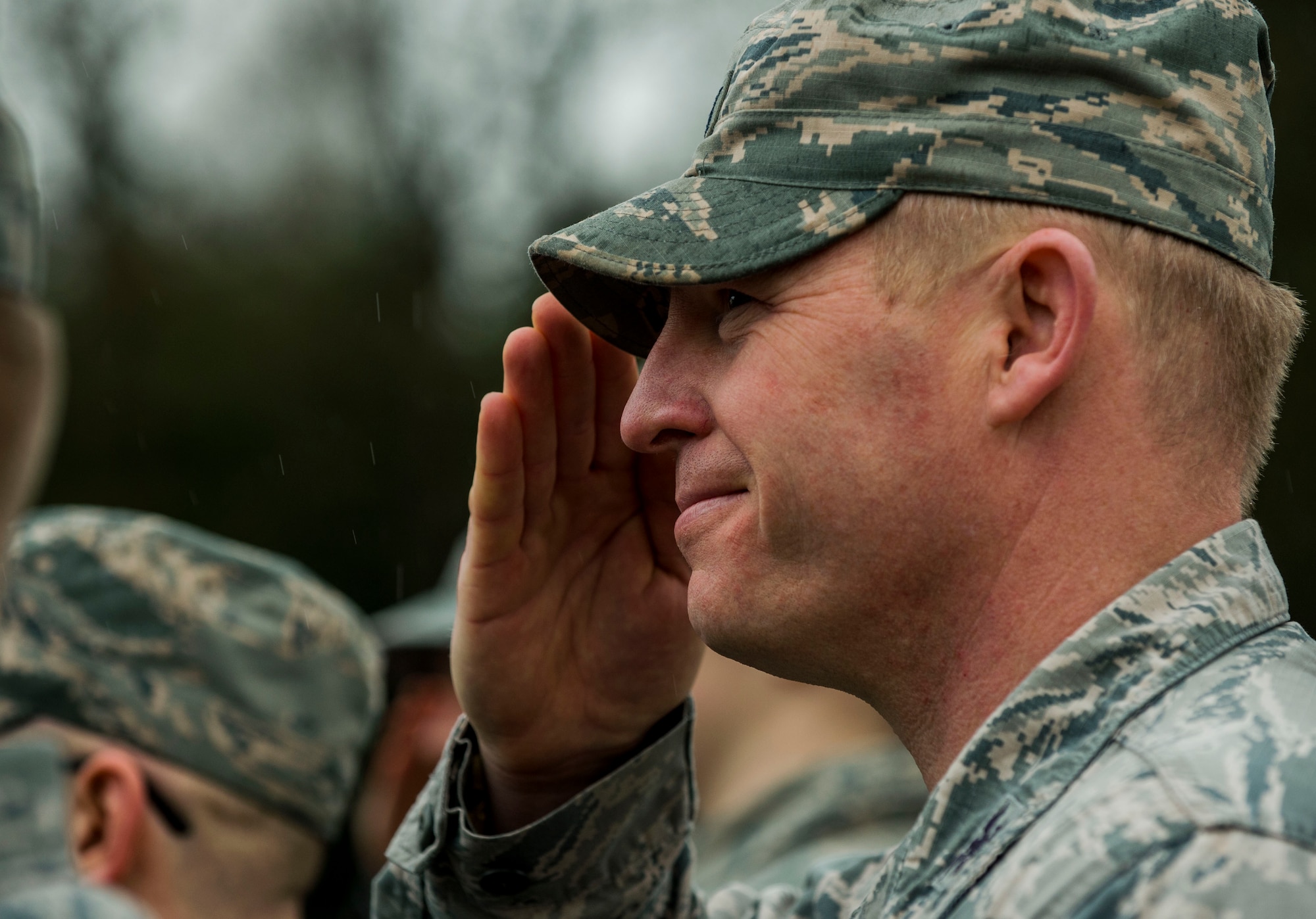U.S. Air Force Col. Joe McFall, 52nd Fighter Wing commander, salutes a passing bus transporting Airmen assigned to the 606th Air Control Squadron before a deployment in front of the 606th ACS main building at Spangdahlem Air Base, Germany, April 5, 2016. The 606th ACS will deploy to six different locations in support of three operations. (U.S. Air Force photo by Airman 1st Class Timothy Kim/Released)
