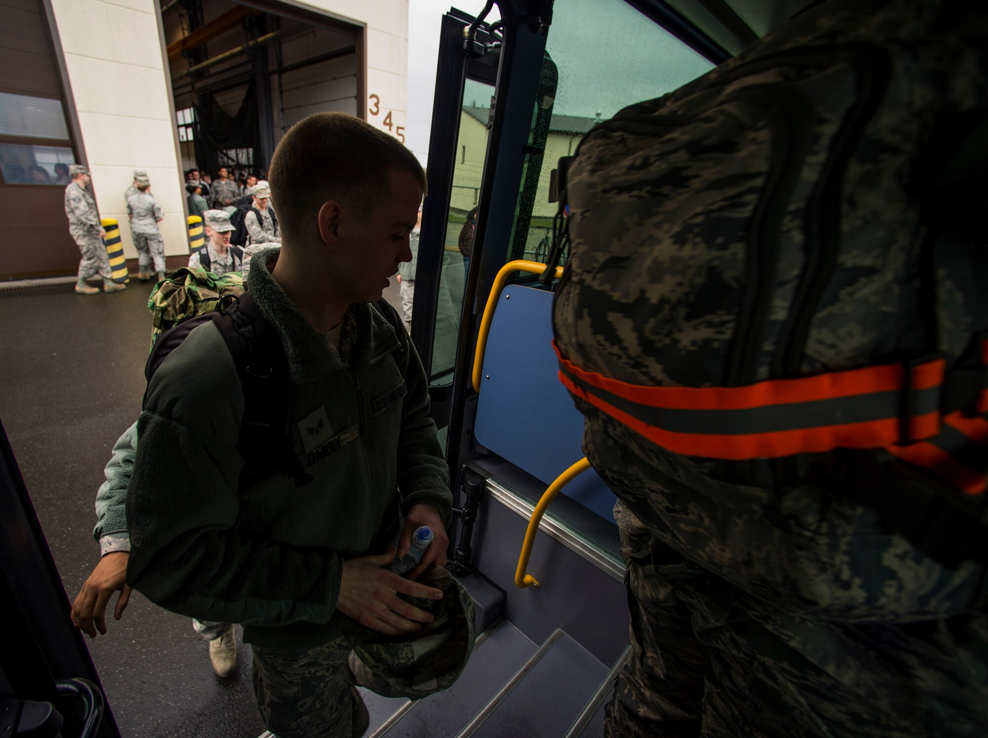 Airmen assigned to the 606th Air Control Squadron board a bus before a deployment in front of the 606th ACS main building at Spangdahlem Air Base, Germany, April 5, 2016. The 606th ACS deployed in support of Operation Freedom Sentinel, Operation Inherent Resolve and combined offense in the Arabian Gulf. (U.S. Air Force photo by Airman 1st Class Timothy Kim/Released)