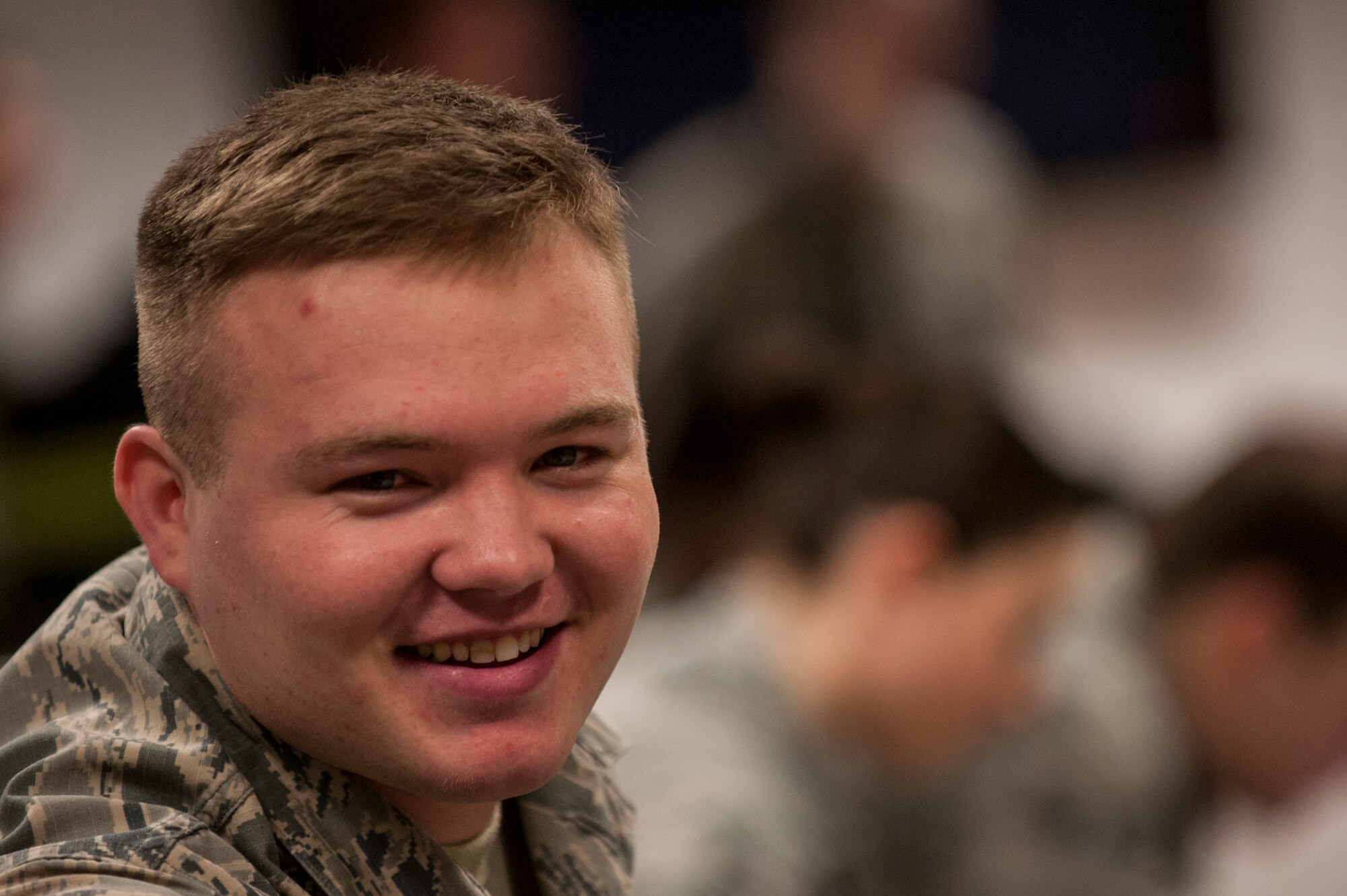 An Airman of the 606th Air Control Squadron smiles as he talks to another member of the 606th ACS prior to departing for a deployment inside a 52nd Logistics Readiness Squadron building prior to departing for a deployment at Spangdahlem Air Base, Germany, April 15, 2016. The 606th ACS will later move to Aviano Air Base, Italy, as a part of the European Infrastructure Consolidation plan following the deployment. (U.S. Air Force photo by Senior Airman Rusty Frank/Released)