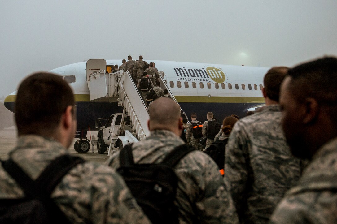 Airmen from the 606th Air Control Squadron board an aircraft on the flightline outside the 726th Air Mobility Squadron passenger terminal at Spangdahlem Air Base, Germany. The 606th ACS is a self-contained mobile combat unit with Airmen covering more than 21 specialties maintaining more than $170 million worth of equipment. (U.S. Air Force photo by Senior Airman Rusty Frank/Released)