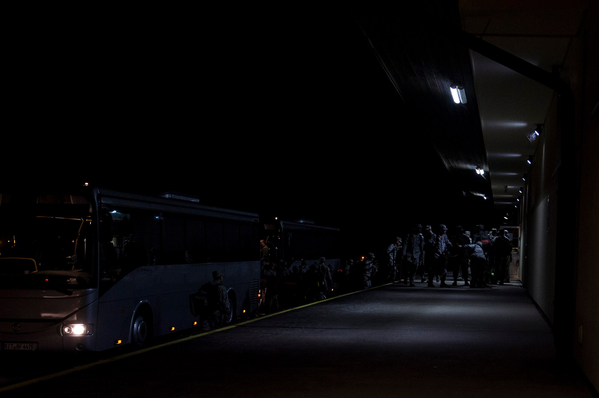 Members of the 606th Air Control Squadron park a bus outside a 52nd Logistics Readiness Squadron building at Spangdahlem Air Base, Germany, prior to departing for a deployment April 15, 2016. The unit will deploy to six different locations in support of multiple operations in Southwest Asia. (U.S. Air Force photo by Senior Airman Rusty Frank/Released)