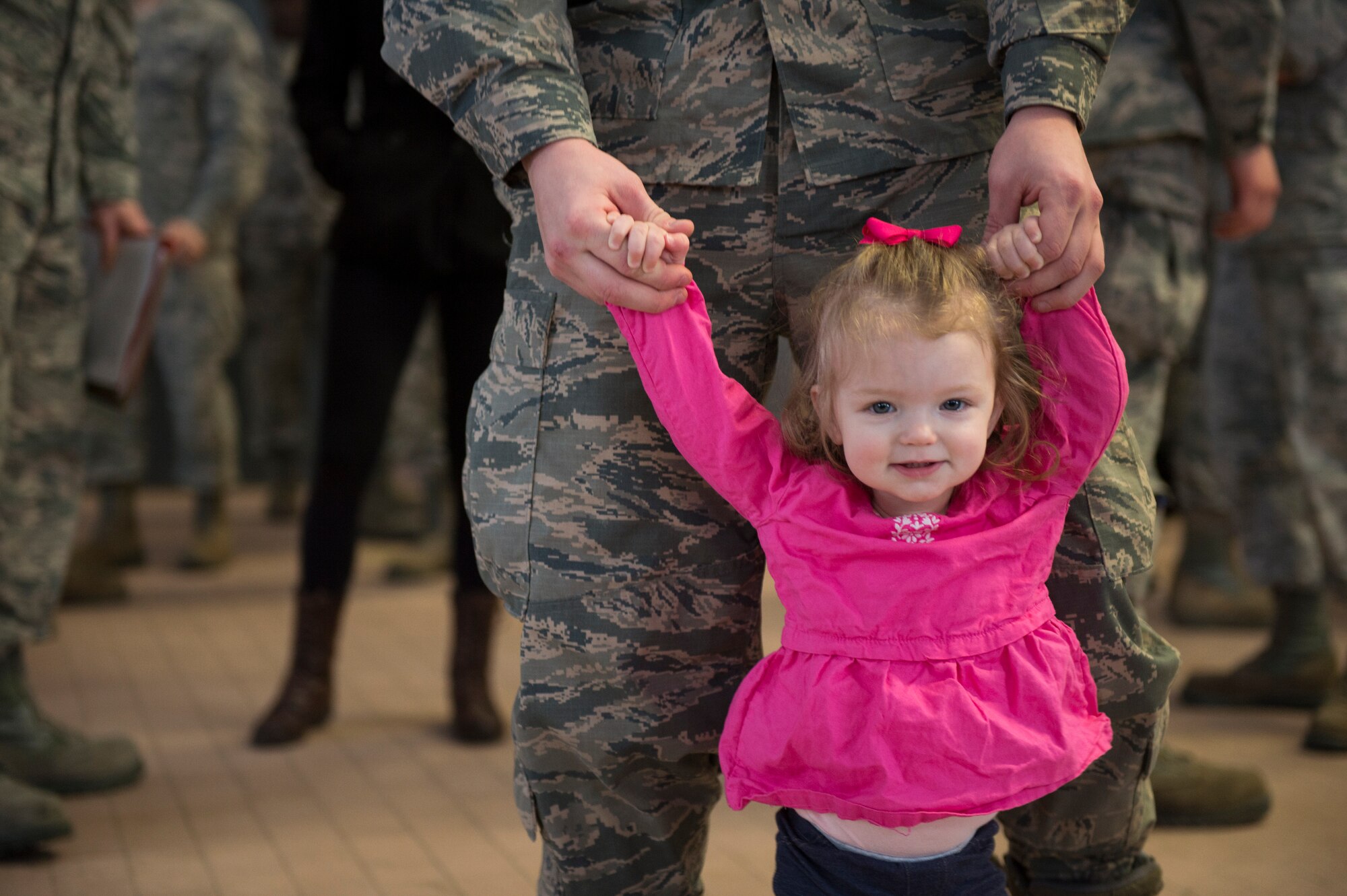 A 606th Air Control Squadron Airman walks around with his daughter before he leaves on a deployment in the 606th ACS compound at Spangdahlem Air Base, Germany, April 5, 2016. The 606th ACS is a self-contained command and control mobile combat unit with Airmen covering more than 21 specialties. (U.S. Air Force photo by Staff Sgt. Christopher Ruano/Released)