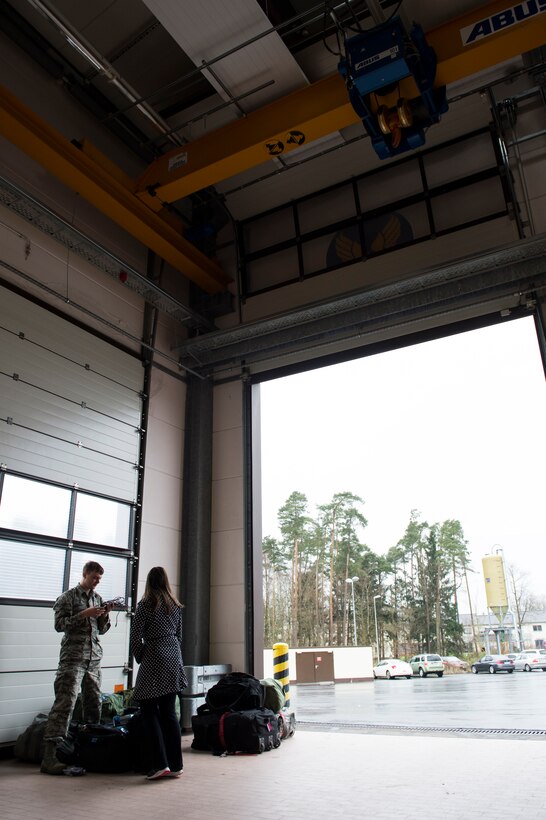 A 606th Air Control Squadron Airman shares a moment with his wife before he leaves on a deployment in the 606th ACS compound at Spangdahlem Air Base, Germany, April 5, 2016. Fellow 606th Airmen and family members were present to see off the deploying Airmen. (U.S. Air Force photo by Staff Sgt. Christopher Ruano/Released)