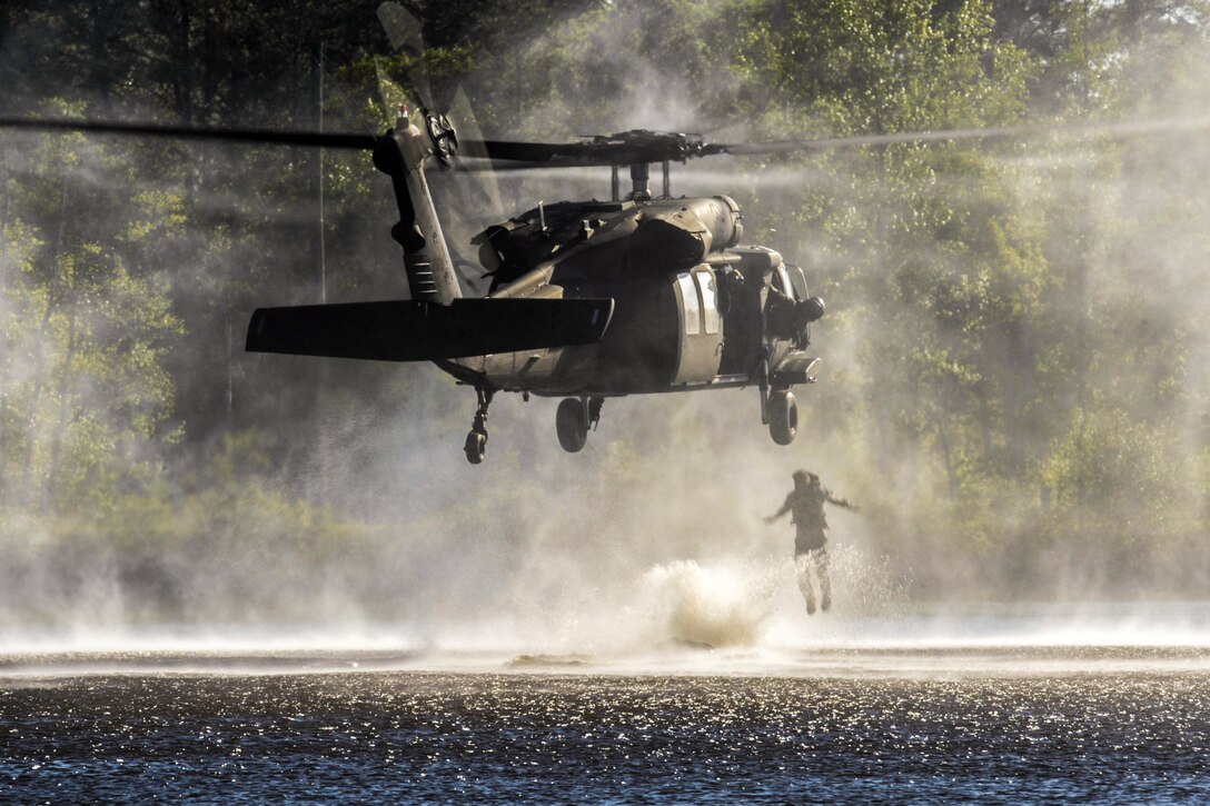 Army Capt. Zakary Long jumps out of a UH-60 Black Hawk helicopter into Victory Pond during a helocast event as part of the Best Ranger Competition at Fort Benning, Ga., April 17, 2016. The three-day competition tested competitors' physical, mental and technical capabilities. Air Force photo by Senior Airman Colville McFee