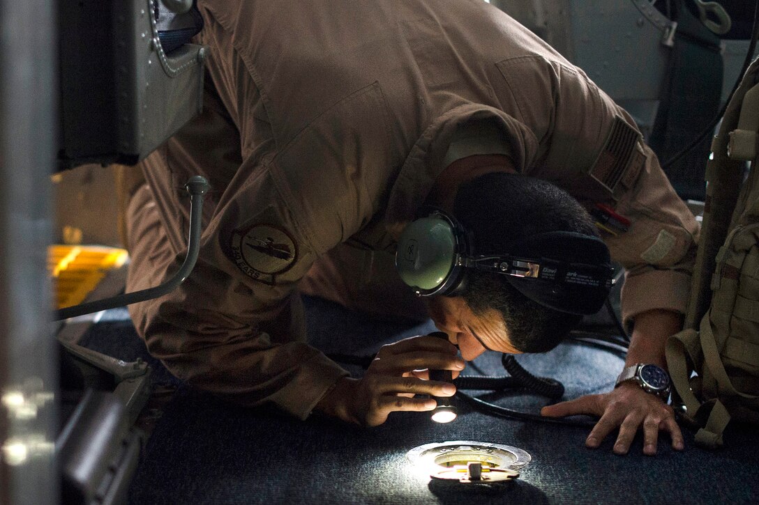 Air Force Senior Airman Castulo checks the front landing gear on a KC-135 Stratotanker aircraft after takeoff from Al Udeid Air Base, Qatar, April 6, 2016. Castulo is an aerial refueling specialist assigned to the 340th Expeditionary Air Refueling Squadron. Air Force photo by Tech. Sgt. Nathan Lipscomb