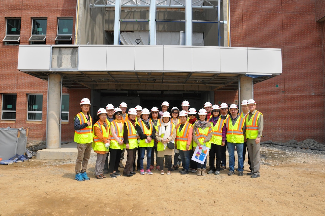 Far East District employees pose for a picture outside the new district headquarters building April 12 at Camp Humphreys. The group were part of an orientation tour designed to give current employees a better understanding of what to expect when the district moves its headquarters to Camp Humphreys next year.