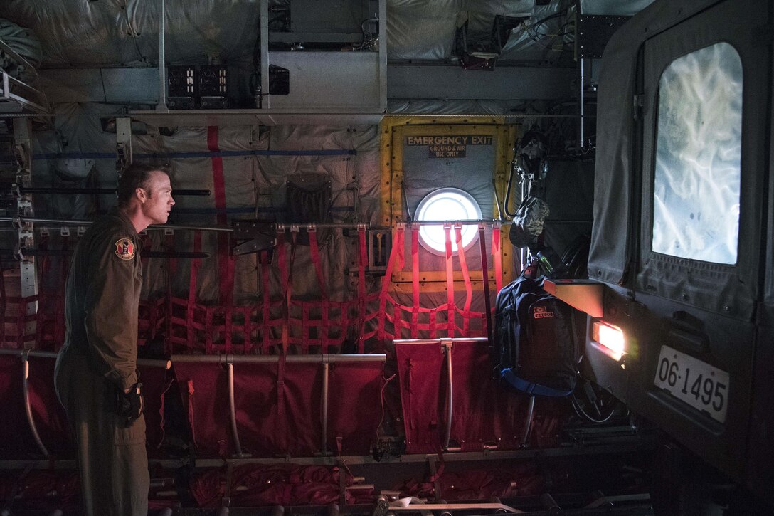 Air Force Master Sgt. Ryan Atkinson checks the clearance as a Japanese army vehicle is backed into a C-130 Hercules aircraft in Chitose, Japan, April 18, 2016. Atkinson is a loadmaster assigned to the 36th Airlift Squadron. Air Force photo by Staff Sgt. Michael Washburn