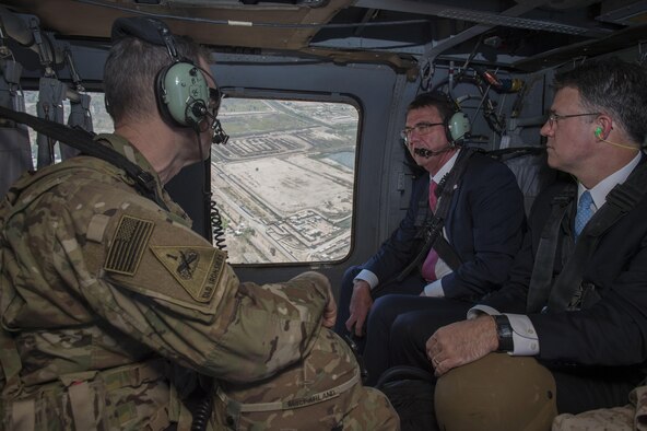 Defense Secretary Ash Carter speaks with Army Lt. Gen. Sean MacFarland, commander of  Combined Joint Task Force Operation Inherent Resolve, as they fly to the Green Zone in a UH-60 helicopter, April 18, 2016. DoD photo by Air Force Senior Master Sgt. Adrian Cadiz