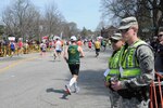 Spc. Mark Mahoney and Spc. Kevin O'Donnell, of Billerica and Canton, Massachusetts, stand along Commonwealth Avenue in Newton as part of the 772nd Military Police Company's mission to provide security in support of local and state police during the Boston Maraton on April 18, 2016.