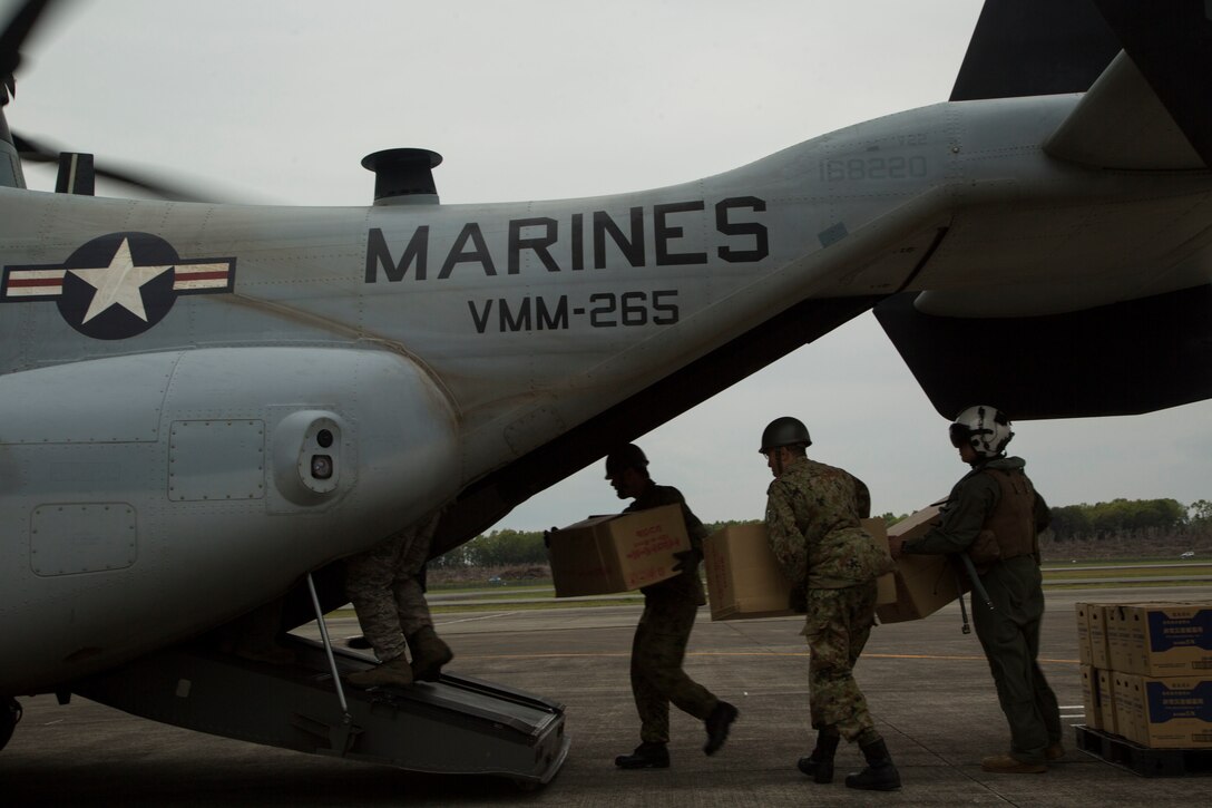 U.S. Marines and Japanese service members load earthquake relief supplies onto MV-22B Ospreys in Japan Ground Self Defense Force Takayumaru Camp, April 18, 2016. The Marines are supporting a large humanitarian relief effort after a series of earthquakes struck the island of Kyushu. U.S. Marine Corps photo by Cpl. Samantha Villarreal