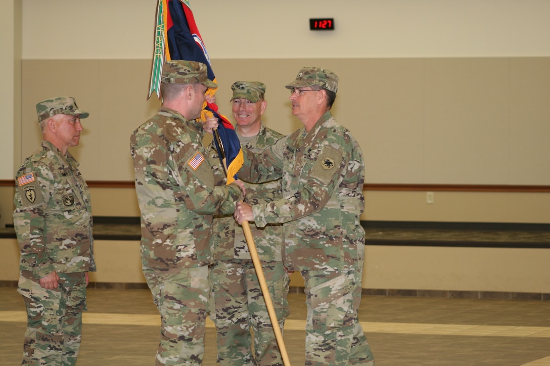 Brig. Gen. Daniel Christian seen smiling after relinquishing command of the 95th Training Division (Initial Entry Training) at Fort Sill, Okla., Apr. 16 at the 95th Adjutant General Battalion. Command Sgt. Maj. John Stumph looks on while Maj. Gen. Mark T. McQueen, Commanding General of the 108th Training Command (IET) headquartered in Charlotte, N.C., hands the division colors to Brig. Gen. Andrew Bassford symbolizing the passing of the responsibility of the mission and care of the Soldiers of the 95th TD. Photo by Capt. Adrienne Bryant 95th Training Division (IET), Public Affairs Officer