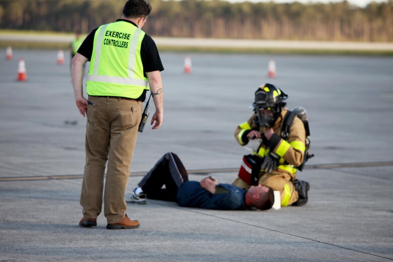 An exercise controller oversees and evaluates a first responder’s tending to a simulated casualty during a Mass Casualty Exercise on Marine Corps Air Station Cherry Point, N.C., April 7, 2016.  The exercise was designed to simulate the response if an emergency were to occur. Annually, the air station is required to have exercises to ensure protocol and safety standards are met for potential emergencies. On years the biannual air show occurs, the training revolves around scenarios specific to that kind of event. (U.S. Marine Corps photo by Cpl. Jason Jimenez/Released)