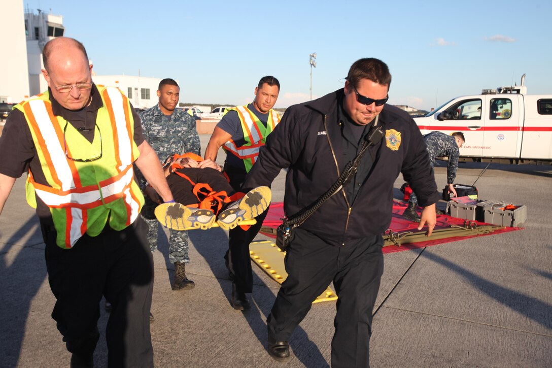 First responders evacuate a simulated casualty during a Mass Casualty Exercise on Marine Corps Air Station Cherry Point, N.C., April 7, 2016.  The exercise was designed to simulate the response if an emergency were to occur. Annually, the air station is required to have exercises to ensure protocol and safety standards are met for potential emergencies. On years the biannual air show occurs, the training revolves around scenarios specific to that kind of event. (U.S. Marine Corps photo by Cpl. Jason Jimenez/Released)