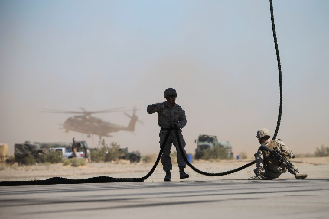 A Marine holds the rope for fellow Marines during a fast-rope exercise from a CH-53E Super Stallion helicopter in Yuma, Ariz., April 1, 2016. Marine Corps photo by Staff Sgt. Artur Shvartsberg