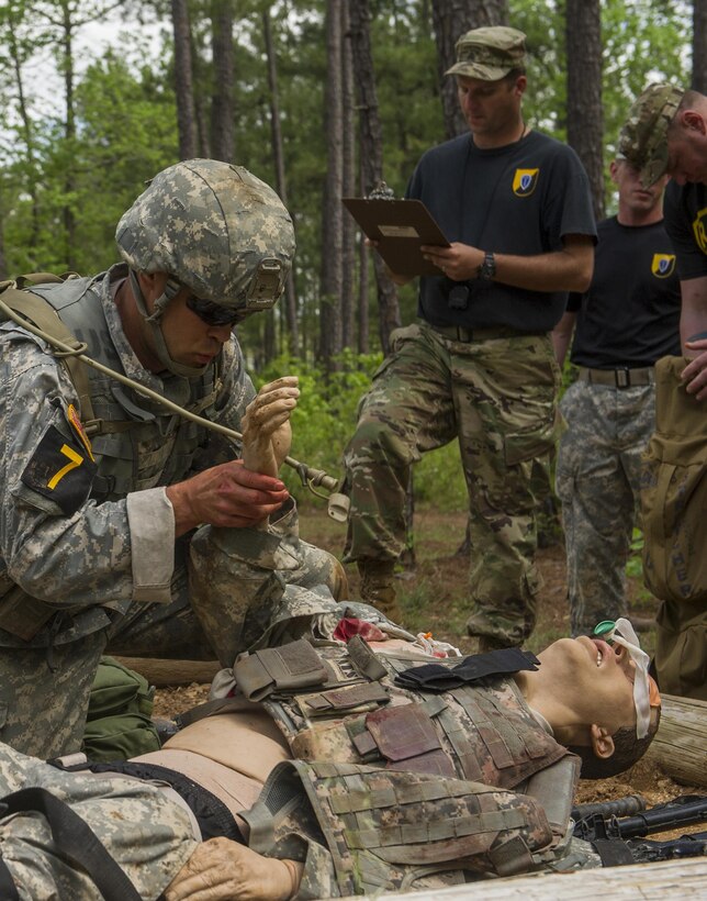 Staff Sergeant (USA) Andrew Balha of the 7th Infantry Division gives casualty care to a training mannequin in the 33rd annual David E. Grange Jr. Best Rangers Competition (BRC) 2016 in Fort Benning, Georgia (USA), on April 16, 2016.

Photo: Cpl Alana Morin, Canadian Forces Joint Imagery Centre
RE16-2016-0004-05