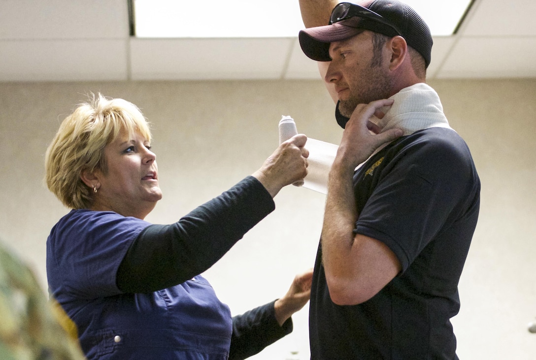 A first aid demonstration is given to U.S. Army Reserve Soldiers before an active shooter training exercise at a training reserve center in Scottsdale, Arizona, April 9. Roughly 150 soldiers were included in the training exercise from various units, to include the 387th Military Police Battalion, the 387th Engineer Battalion and the 91st Operations Training Division. (U.S. Army photo by Sgt. Jennifer Spiker)