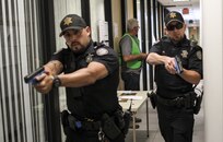 Officers from the Scottsdale Police Department search a building for an active shooter during a training exercise involving U.S. Army Reserve Soldiers in Scottsdale, Arizona, April 9. Roughly 150 soldiers were included in the training exercise from various units, to include the 387th Military Police Battalion, the 387th Engineer Battalion and the 91st Operations Training Division. (U.S. Army photo by Sgt. Jennifer Spiker)