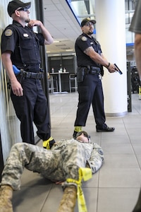 Officers from the Scottsdale Police Department capture a role-playing active shooter during a training exercise with U.S. Army Reserve Soldiers at a training center in Scottsdale, Arizona, April 9. Roughly 150 soldiers were included in the training exercise from various units, to include the 387th Military Police Battalion, the 387th Engineer Battalion and the 91st Operations Training Division. (U.S. Army photo by Sgt. Jennifer Spiker)