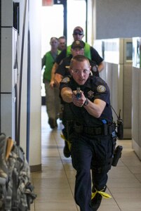 Officers from the Scottsdale Police Department search a building for an active shooter during a training exercise with U.S. Army Reserve Soldiers at a training center in Scottsdale, Arizona, April 9. Roughly 150 soldiers were included in the training exercise from various units, to include the 387th Military Police Battalion, the 387th Engineer Battalion and the 91st Operations Training Division. (U.S. Army photo by Sgt. Jennifer Spiker)