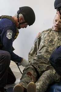 Firefighters from the Scottsdale Fire Department administer first aid to a medical dummy during a training exercise with U.S. Army Reserve Soldiers at a training center in Scottsdale, Arizona, April 9.  Roughly 150 soldiers were included in the training exercise from various units, to include the 387th Military Police Battalion, the 387th Engineer Battalion and the 91st Operations Training Division. (U.S. Army photo by Sgt. Jennifer Spiker)