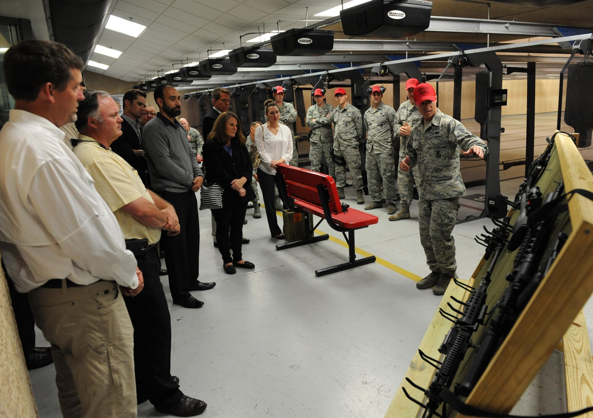 Senior Airman Caleb Gilliard, 81st Security Forces Squadron combat arms instructor, shows a weapons display at the 81st SFS combat arms training and maintenance building during an honorary commanders 81st Mission Support Group orientation tour April 14, 2016, Keesler Air Force Base, Miss. The honorary commander program is a yearly partnership between base leadership and local civic leaders to promote strong ties between military and civilian leaders. (U.S. Air Force photo by Kemberly Groue)