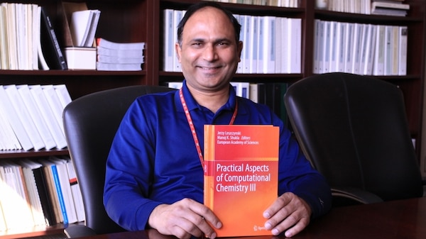 Dr. Manoj K. Shukla, research physical scientist for the Engineer Research and Development Center displays the book he and and Dr. Jerzy Leszczynski, professor and presidential distinguished fellow, Jackson State University edited that was released in April 2016. Fourth in a series of books on computational chemistry, "Practical Aspects of Computational Chemistry III", was published by Springer.
