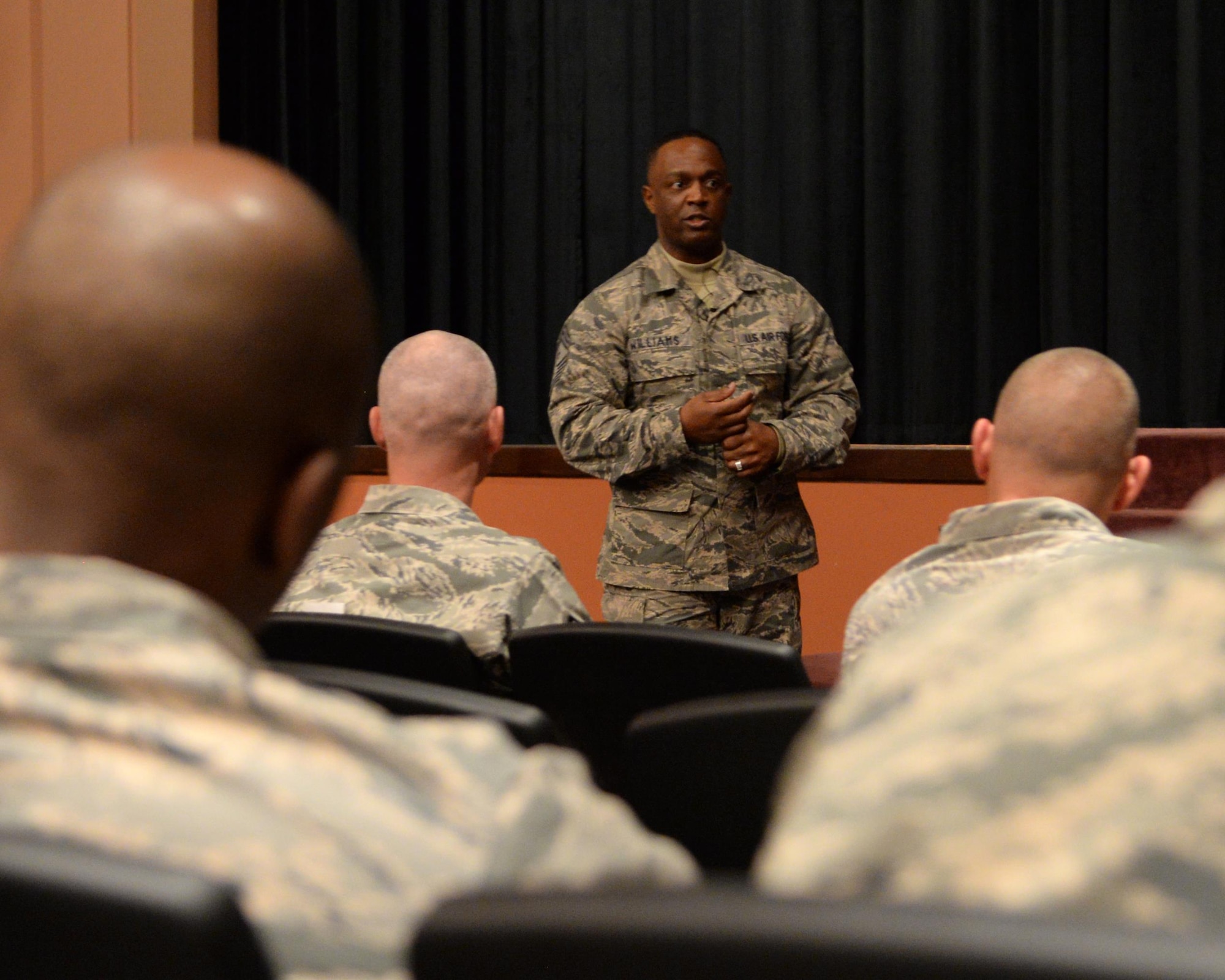 Chief Master Sgt. Calvin Williams, Air Force Global Strike Command command chief, speaks during an enlisted all-call on F.E. Warren Air Force Base, Wyo., in the base theater April, 13, 2016. Promotions and professionalism were the key topics of discussion during his visit. (U.S. Air Force photo by Airman 1st Class Malcolm Mayfield)