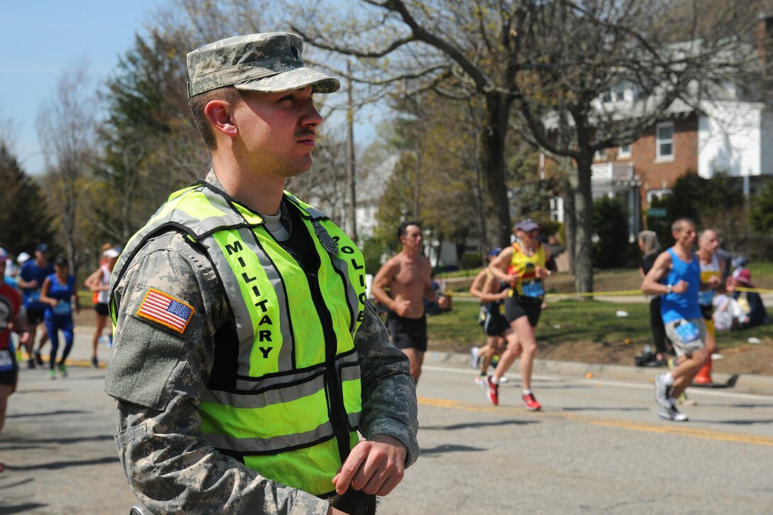 An Army military policeman provides security as runners participate in the 120th Boston Marathon in Newton, Mass., April 18, 2016. Massachusetts Army National Guard photo