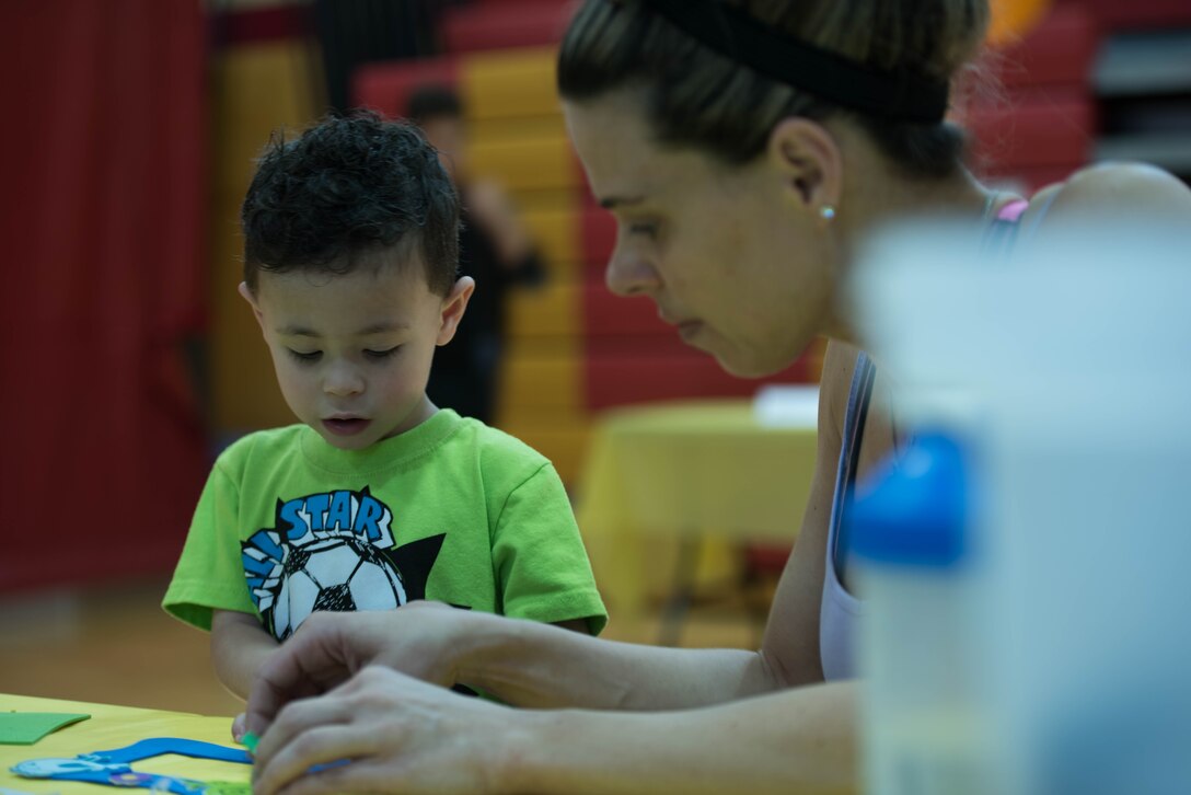 A mother and son work on some arts and craft while a the Children’s Fair at Henderson Hall in Arlington, Va. April 16, 2016. The Children’s Fair is a way of showing support for military children and parents (Photo by Lance Cpl. Timothy R. Smithers/ Released)