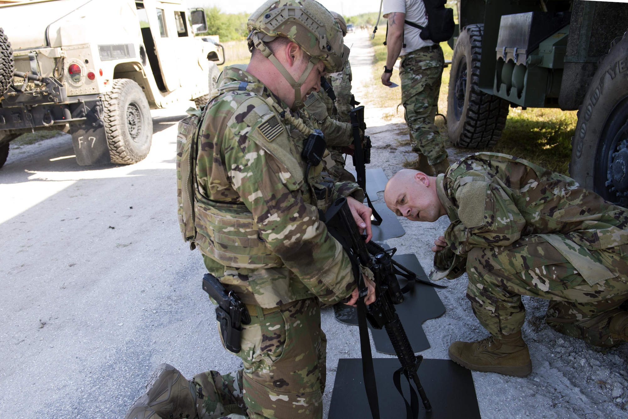 U.S. Air Force Capt. Matthew Kline, 712th Air Support Operations Squadron flight commander, inspects  Tech. Sgt. Jon Kennedy’s, 10th ASOS tactical air control party chief of standard evaluations,  M4 carbine rifle during the weapon disassembly portion of an obstacle course, April 13, 2015, at Avon Park Air Force Range, Fla. With ‘Spartans’ as far west as Fort Bliss, Texas and as far north as Fort Drum, N.Y., the squadron’s battlefield Airmen synchronized and shared ideas as they were evaluated on their preparatory skills when rapidly deploying to provide expeditionary support in contingency operations. (U.S. Air Force photo by Airman 1st Class Greg Nash/Released)
