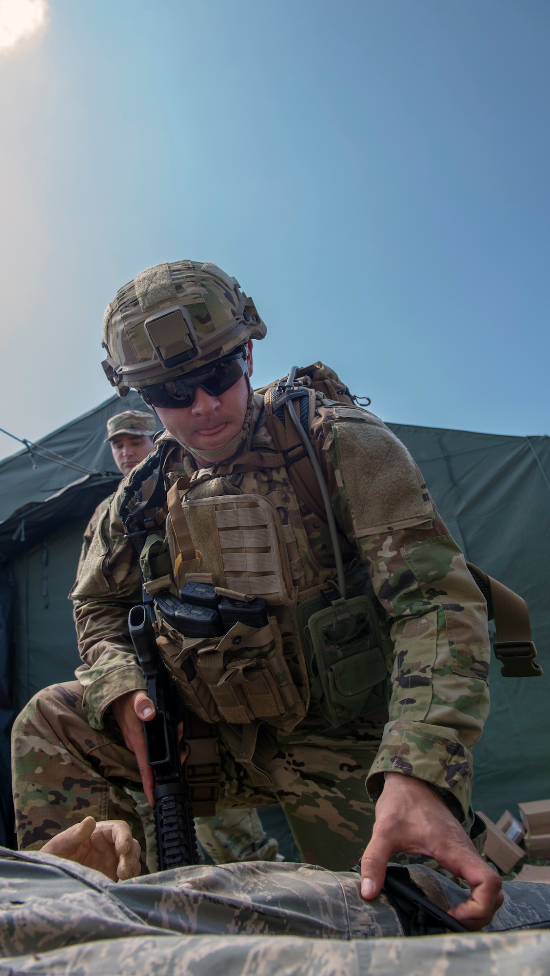 U.S. Air Force Senior Airman Jeremy Sanford, 9th Air Support Operations Squadron tactical air control party specialist, places a tourniquet on a dummy during a self-aid buddy care training scenario, April 13, 2016, at Avon Park Air Force Range, Fla. 12 Airmen from each squadron were split up in teams to compete while performing various training scenarios, targeting their expeditionary skills and functional-area knowledge under duress and high-intense conditions. Ruck-marches, weapon disassembly and assembly, and an obstacle course were among the training events. (U.S. Air Force photo by Airman 1st Class Greg Nash/Released)