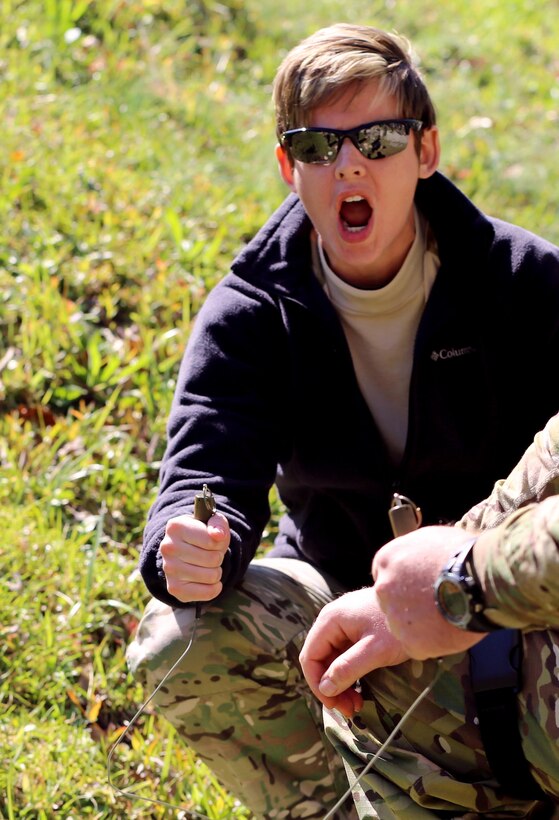 Carteret County Special Response Team Cpl. Jordan Seitter shouts a verbal warning while preparing to detonate explosives on a range at Marine Corps Air Station Cherry Point, N.C., April 13, 2016. The Carteret County SRT completed training in the morning with Cherry Point’s Explosive Ordnance Disposal Marines before testing their knowledge at the range. The training was meant to help the team understand how to handle situations dealing with these explosives. The team used C-4, TNT and dynamite in the demonstration. Seitter is an operator with the Carteret County SRT. (U.S. Marine Corps photo by Lance Cpl. Mackenzie Gibson/ Released)