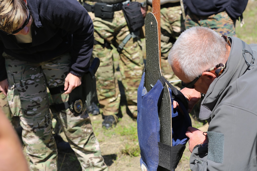 Members of the Carteret County Special Response Team observe the influence of a grenade blast on a vest at Marine Corps Air Station Cherry Point, N.C., April 13, 2016. The training was meant to help Carteret County SRT understand how to handle situations dealing with explosives. The course covered improvised explosive devices, military munitions, military and civilian explosives, drug and explosive labs, homemade explosives, explosive ordnance disposal response procedures, and a range demonstration using C-4, TNT and dynamite. (U.S. Marine Corps photo by Lance Cpl. Mackenzie Gibson/ Released)