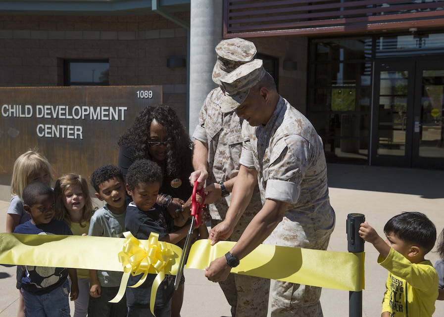 Col. Jay Wylie, assistant chief of staff, G-4 Installations and Logistics and Lt. Col. Frank Marilao, assistant chief of staff, Marine Corps Community Services, conduct the ribbon-cutting ceremony for the Child Development Center aboard the Combat Center April 13, 2016. The development center, also known as ‘Stepping Stones’, is a 37,000-square-foot facility. (Official Marine Corps photo by Cpl. Connor Hancock/Released)