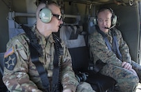 Army Command Sgt. Maj. John W. Troxell, senior enlisted advisor to the chairman of the Joint Chiefs of Staff, speaks to Marine Corps Gen. Joe Dunford, the chairman of the Joint Chiefs of Staff, aboard a UH-60 Black Hawk helicopter in Hawaii, Feb. 9, 2016.